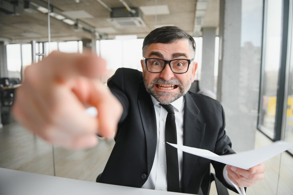 Angry boss behind of office table