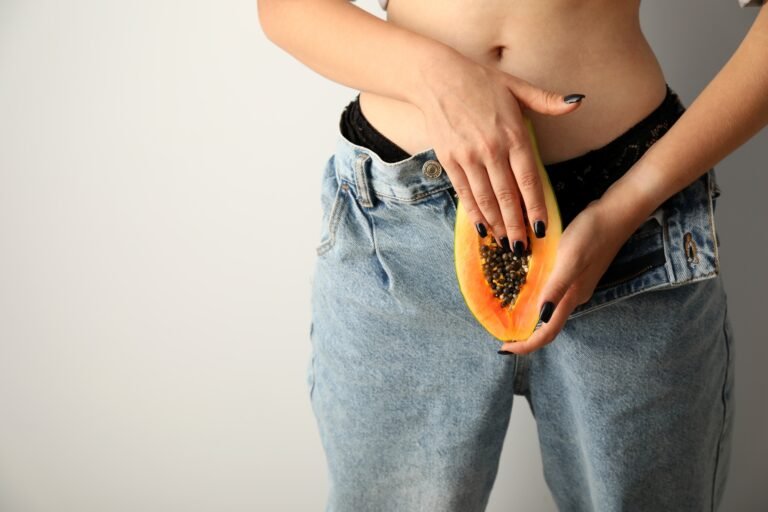 Masturbation concept with woman holding papaya, space for text